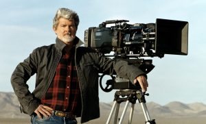 Director George Lucas is shown standing next to a digital movie camera used to shoot, 'Star Wars: Episode II Attack of the Clones,' on the set of the film, in this undated photo. Lucas shot the entire film using digital cameras and hoped to have the film shown with digital projectors in theaters. Studio and theater executives counter that the technology is not ready for mass use and that complex questions remain on setting industry-wide standards, avoiding piracy and financing digital-projection systems, which can cost up to $150,000 for each screen. (AP Photo/Lucasfilm Ltd.)