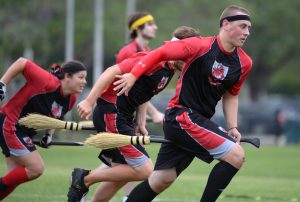 Grown humans playing quidditch.